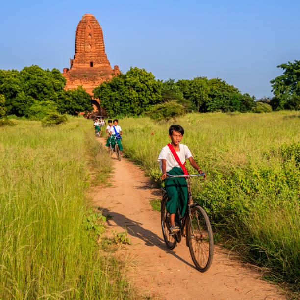 istock Burmese school children riding a bicycle in Bagan, Myanmar 1128461610
