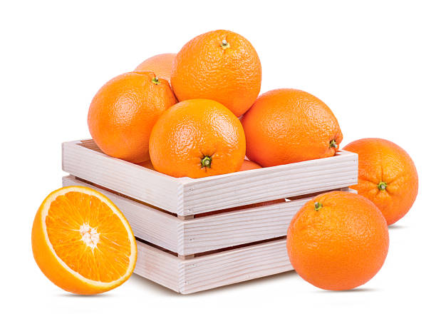 istock Oranges in a wooden box isolated on white background with clipping path 1128464185