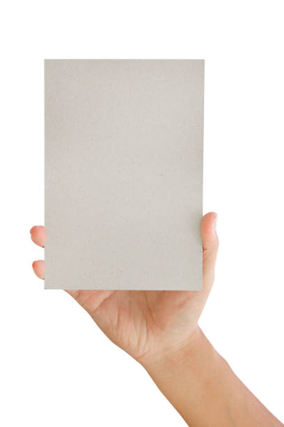 istock Male hand holding gray a blank paper - clipping paths. 1128466233
