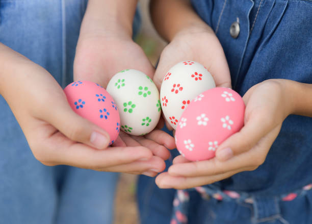 istock Happy Easter Day. Easter eggs concept. Colorful easter eggs in children hands after egg hunting. 1128468435