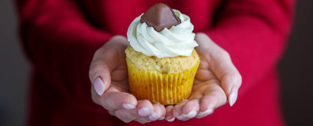istock Cupcake with vanilla cream and candy. Banner. Concept for food, desserts, bakery, celebration, birthday 1128469536