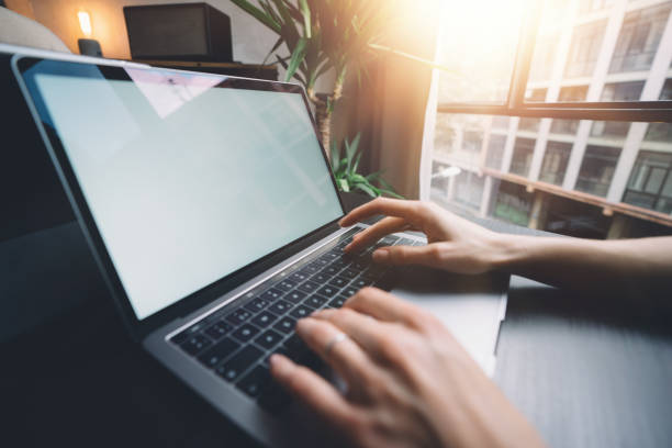 istock Female hands typing on laptop keyboard at the office. Closeup 1128469830