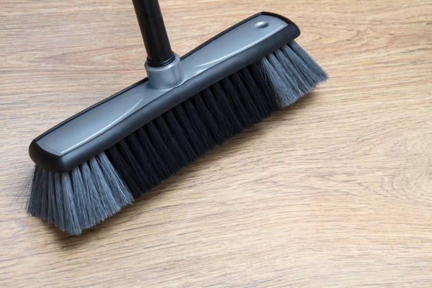istock Broom against wooden laminate floor 1128473177