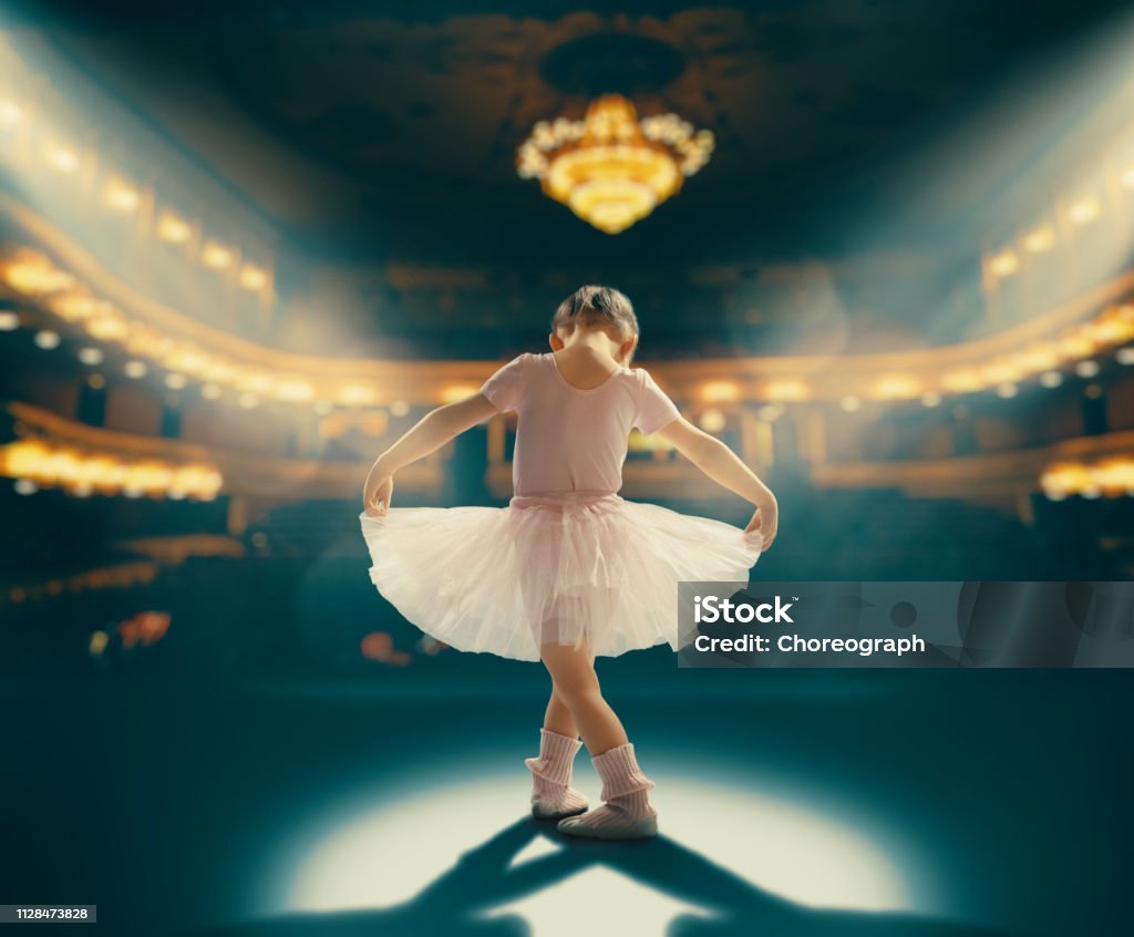 girl dreaming of becoming a ballerina Cute little girl dreaming of becoming a ballerina. Child girl in a pink tutu dancing on the stage. Baby girl is studying ballet. Child Stock Photo