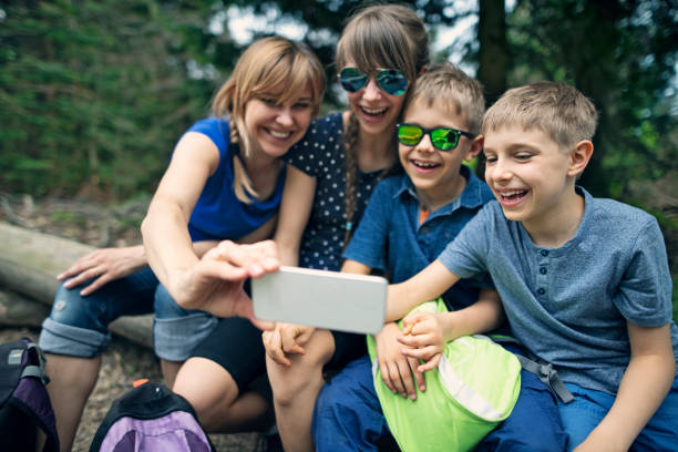 istock Hiking family taking selfies in forest 1128475748