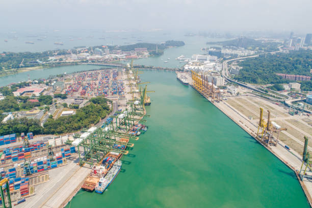 istock Logistics and transportation of Container Cargo ship and Cargo working crane bridge in shipyard 1128475898