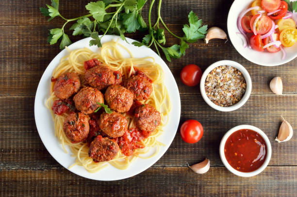 istock Meatballs and spaghetti on white plate 1128477341
