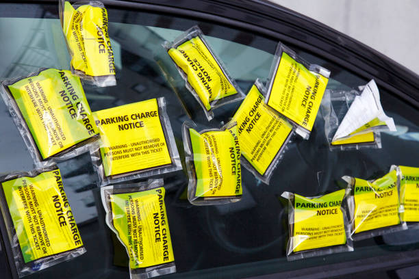 Parking Ticket on a Car - UK A car has numerous yellow parking tickets on the side window. It is parked in a restricted zone with residenial parking only. no parking sign photos stock pictures, royalty-free photos & images