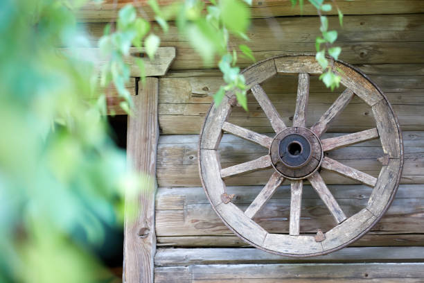 istock Background with a tree and a wheel. Russia . village 1128479430