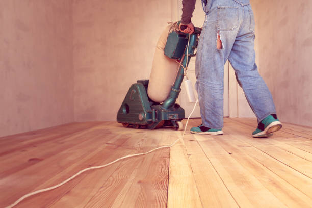 istock carpenter works by electric grinding wood machine in a room 1128480015