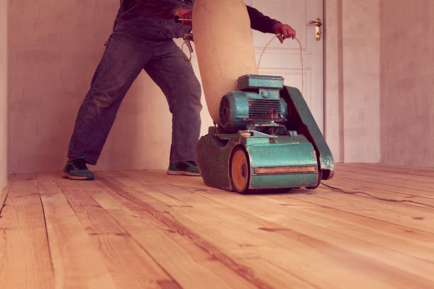 istock carpenter works by electric grinding wood machine in a room 1128480016