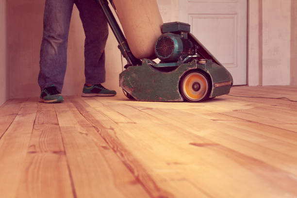 istock carpenter works by electric grinding wood machine in a room 1128480017