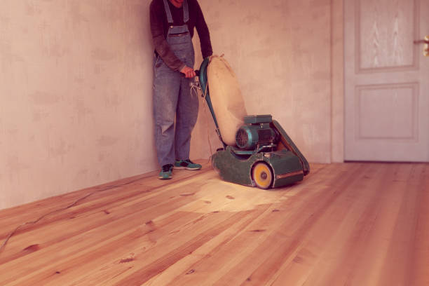 istock carpenter works by electric grinding wood machine in a room 1128480019