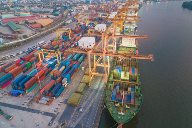 istock Logistics and transportation of Container Cargo ship and Cargo working crane bridge in shipyard 1128480958