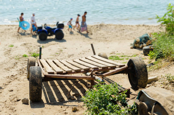 istock Boat trailer on the sea sandy beach 1128482027
