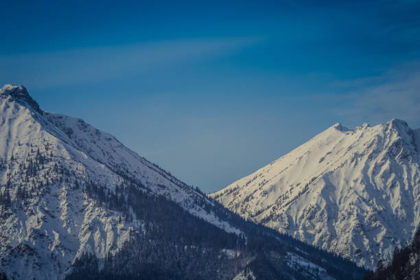 istock Panoramic view of the European Alps, dark, cloudy background concept 1128482044