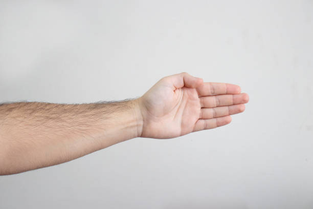 istock Close-Up Male Pointing His Arm and Palm Hand to a Direction 1128482321