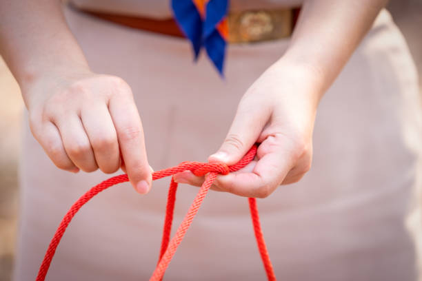 istock Knot scout learning and teaching in camping scout in hills 1128485344