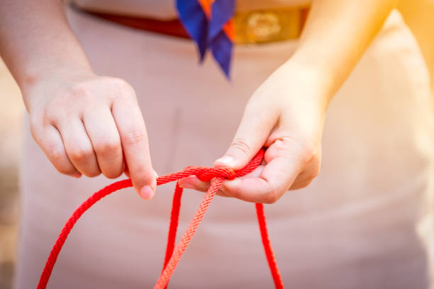 istock Knot scout learning and teaching in camping scout in hills 1128485347
