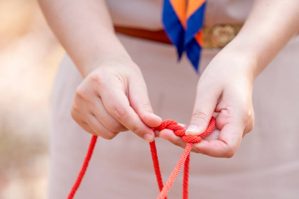 istock Knot scout learning and teaching in camping scout in hills 1128485373