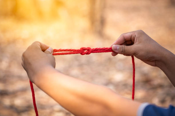 istock Knot scout learning and teaching in camping scout in hills 1128485508