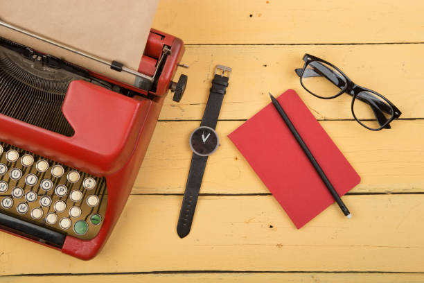 istock Journalist or private detective workplace - typewriter, and other stuff on the yellow planks 1128485561