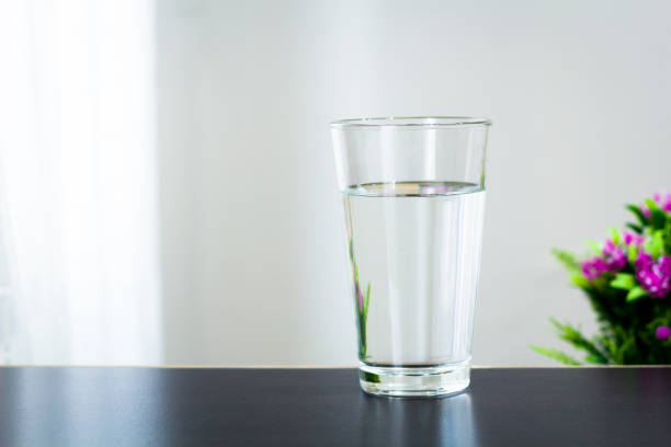istock Glass of water on the table background 1128486128