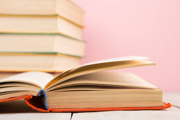 istock education and wisdom concept - open book on wooden table, color background 1128487202