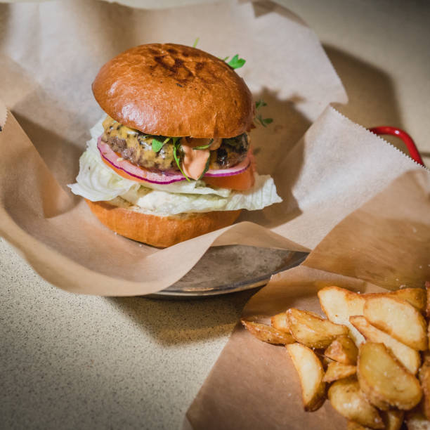istock Burger and cheeseburger with french fries 1128490427