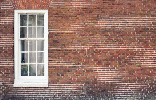 Photo of Brick wall with window and copy space