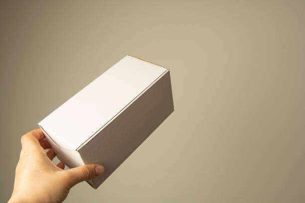 istock Hand holding blank white box , mock up. copy space. Packing and delivery concept. 1128492002