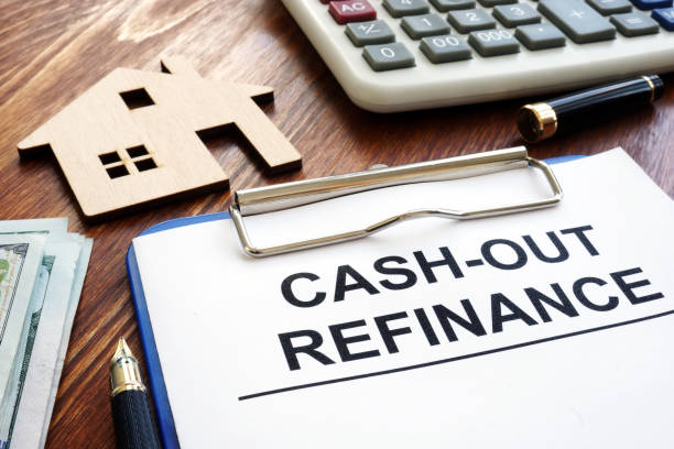 istock Cash out refinance documents and model of house. 1128492060