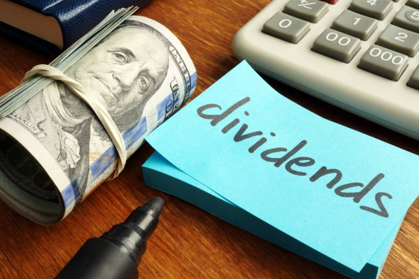 istock Dividends concept. Stack of dollars and calculator. 1128492098