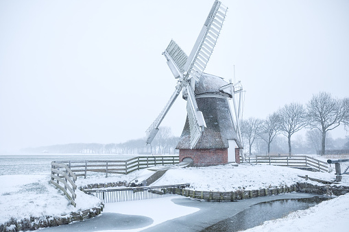 Dutch windmill in snow during winter, Netherlands
