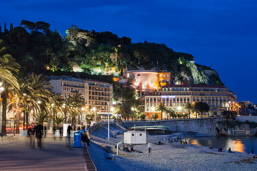 City of Nice by night in France, beach and promenade on French Riviera (Cote d'Azur) picturesque coastline.