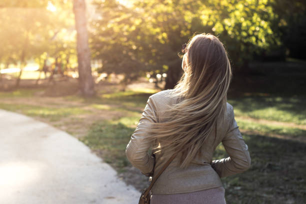 istock Woman walking at sunset 1128497859