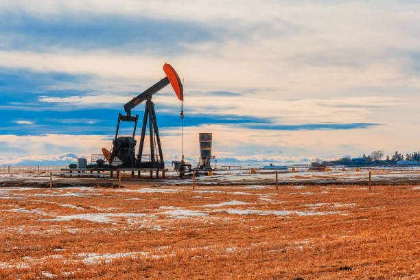 istock Oil Well Pumping on a Barren Landscape 1128500125