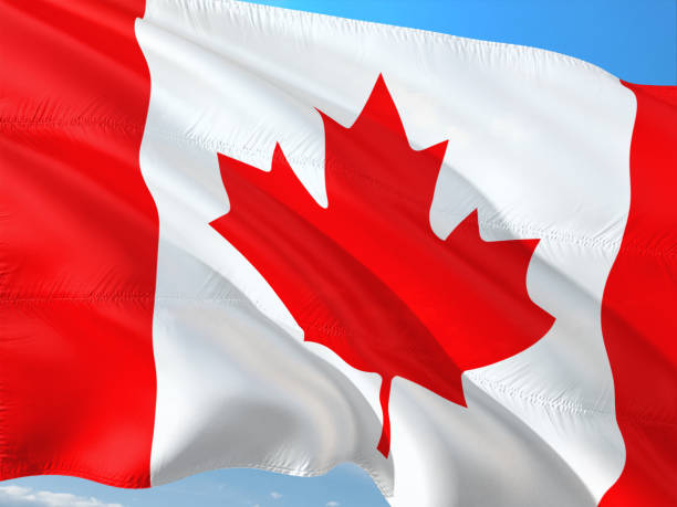 istock Flag of Canada waving in the wind against deep blue sky. High quality fabric. 1128501020