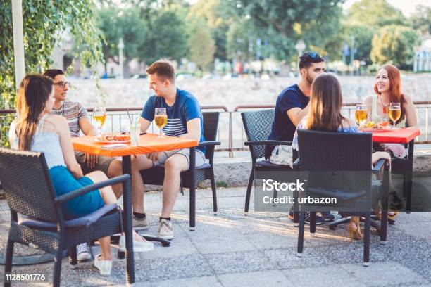 Young People Relaxing In Patio Section Stock Photo - Download Image Now - Patio, Restaurant, Bar - Drink Establishment