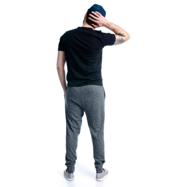 istock Man in black t-shirt with cap looks 1128502536