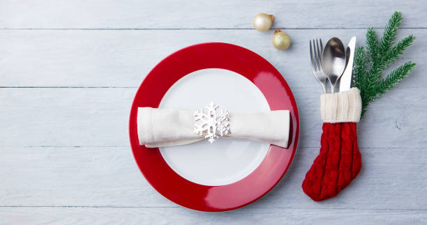 istock Christmas, New Year celebration place table setting. Wooden background. Copy space. Top view. 1128503530