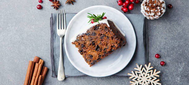 pastel de frutas de navidad, con leche en plato blanco. copia espacio. vista superior. - marzipan fruit celebration dessert fotografías e imágenes de stock