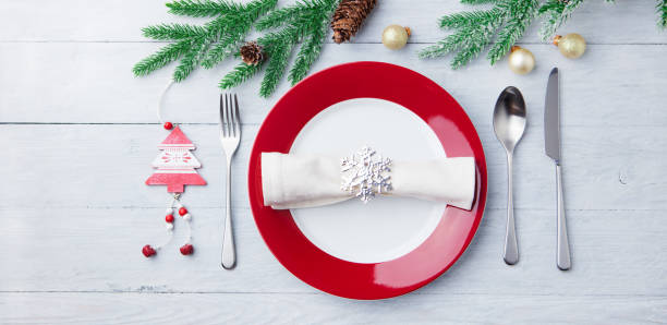 istock Christmas, New Year celebration place table setting. Wooden background. Top view. 1128505367