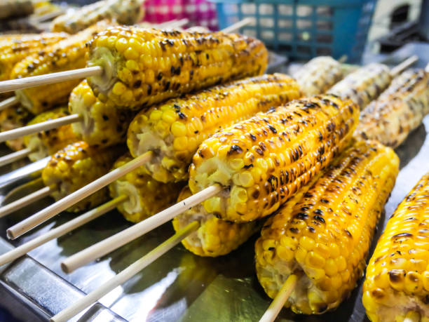 Delicious grilled corn, Grilled corns on the grille over fire at night market