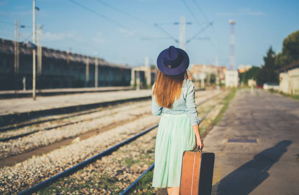 istock Woman walking and waits train 1128508023