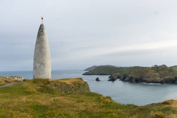 istock Old stone lighthouse lots frau baltimore beacon in ireland with coast 1128509872