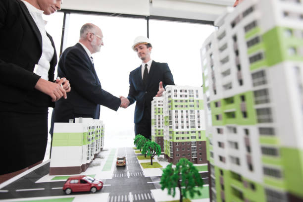 istock Business handshake of architect and investor 1128512982