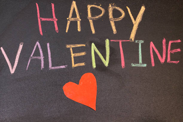 istock Valentine Day concept on black chalkboard. colorful text, Love theme. 1128513070