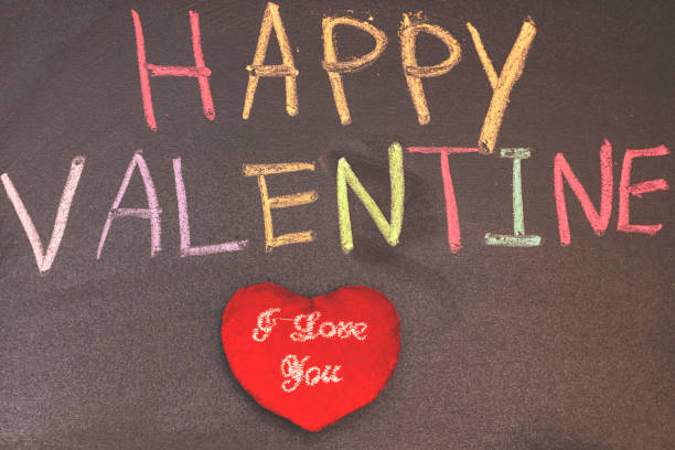 istock Valentine Day concept on black chalkboard. colorful text, Love theme. 1128513930