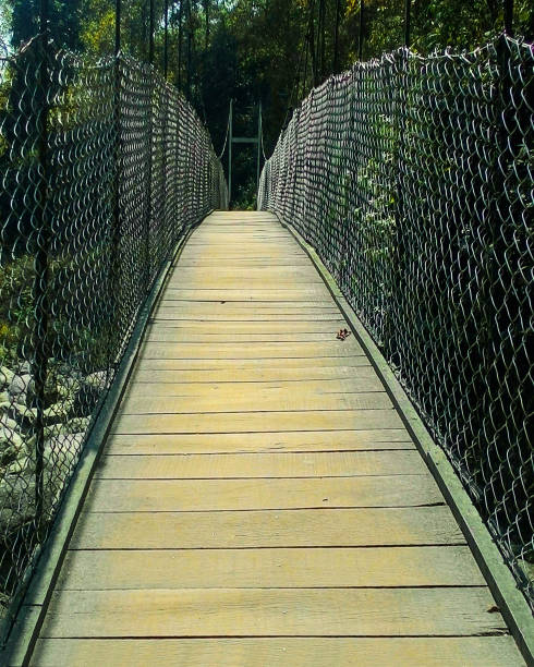 istock Bridge in the middle of hills. 1128515017